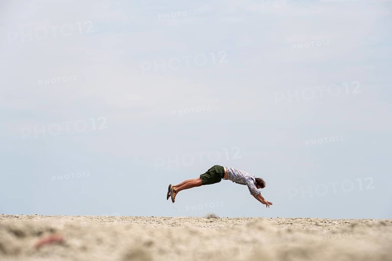 Abstract, man jumping horizontally at the Etosha pan, salt pan, Etosha National Park, Namibia