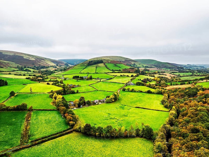 Autumn colours of Farms over River Wye and Road A470 from a drone, Llanidloes, Powys, Montgomeryshire, Wales, UK