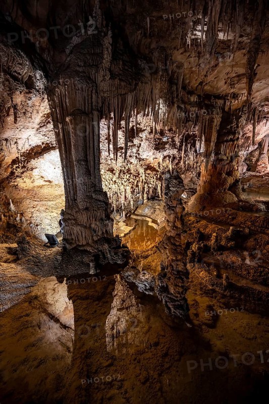 Stalactites and stalagmites reflected in water basins, rock formations in a stalactite cave, Grotta del Fico, Gulf of Orosei, Baunei, Sardinia, Italy