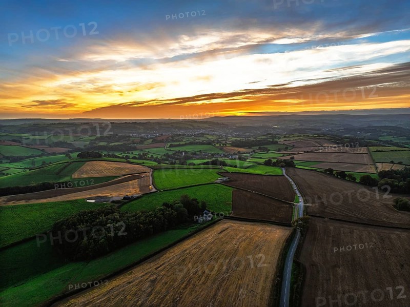 Sunset of Devon Farms and Fields over Berry Pomeroy from a drone, Totnes, England, United Kingdom