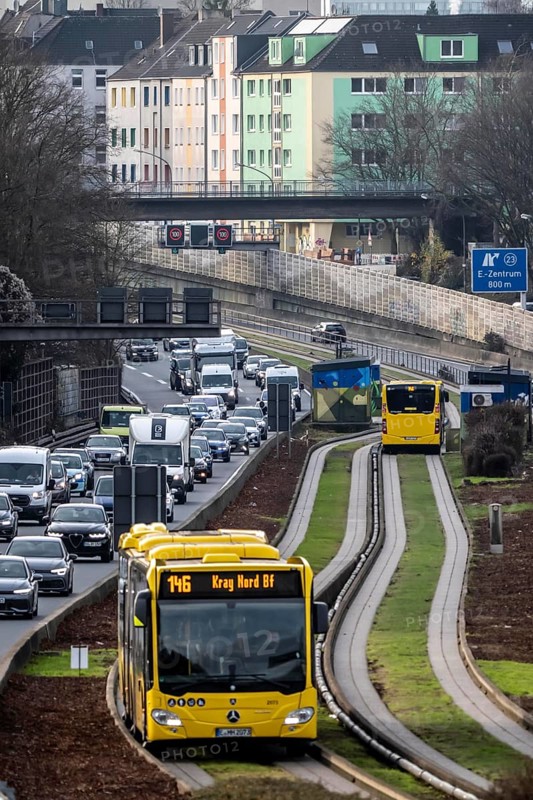 Heavy traffic on the A40 motorway, Ruhrschnellweg, height of the Essen-Ost motorway junction, view to the west, 6-lane motorway, with 2 bus lanes in the middle, rush hour traffic, North Rhine-Westphalia, Germany