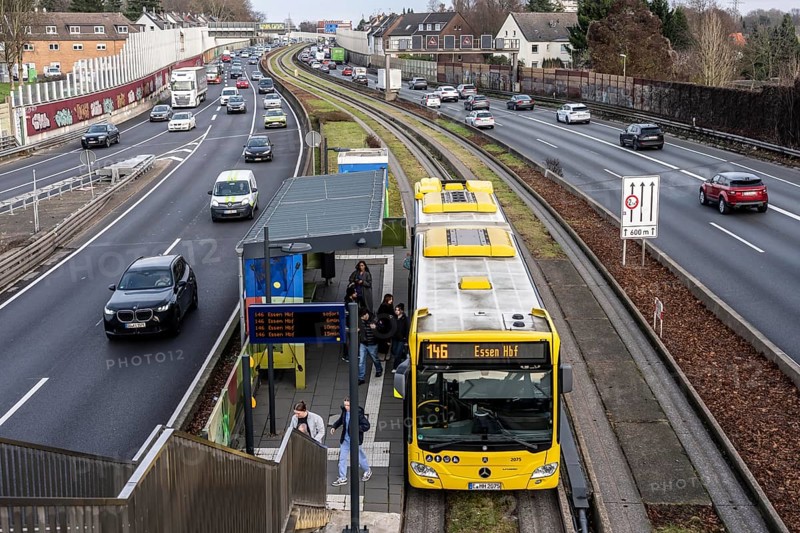 Heavy traffic on the A40 motorway, Ruhrschnellweg, height of the Essen-Ost motorway junction, looking east, 6-lane motorway, with 2 bus lanes in the middle, Essen Feldhaushof bus stop, rush hour traffic, North Rhine-Westphalia, Germany