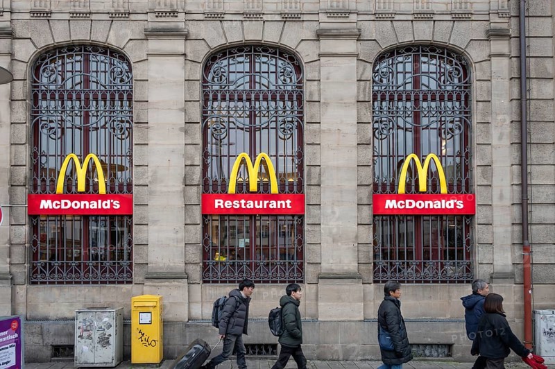 McDonald's logos on the historic lattice windows of the Old Post Office, Erlangen, Mittelfranklen, Bavaria, Germany