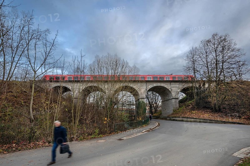Regional train travels over the historic stone railway viaduct, built in 1876, Lauf an der Pegnitz, Middle Franconia, Bavaria, Germany