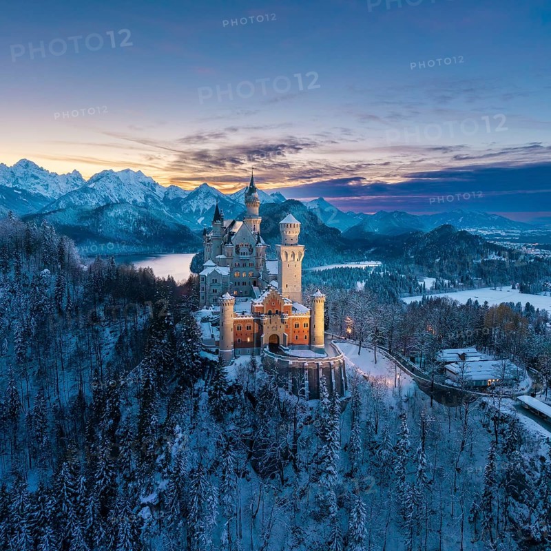 Snowy Neuschwanstein Castle surrounded by alpine mountains at dusk, Schwangau near Füssen, Ostallgäu, Allgäu, Bavaria, Germany