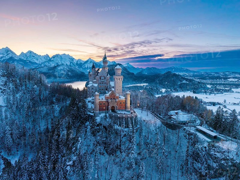 Winter evening with Neuschwanstein Castle and a peaceful landscape of mountains and snow in soft light, Schwangau near Füssen, Ostallgäu, Allgäu, Bavaria, Germany