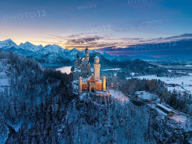 Picturesque Neuschwanstein Castle in winter at dusk with alpine panorama, Schwangau near Füssen, Ostallgäu, Allgäu, Bavaria, Germany