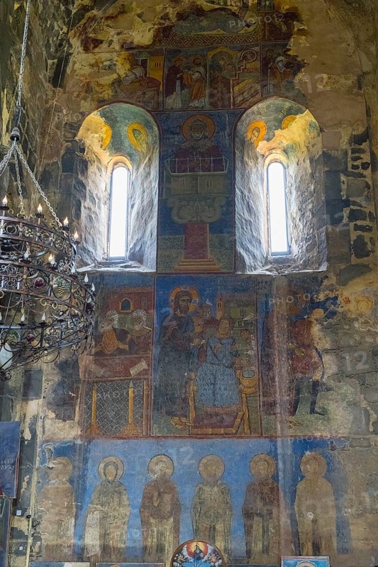 Historical wall paintings under windows in a bright church interior, Akhtala monastery, Akhtala town, Lorikeet province, Armenia