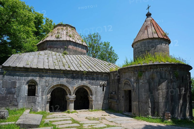 Historic monastery with two domes, overgrown roofs and stone structures under clear skies, Sanahin monastery, town of Sanahin, UNESCO World Heritage Site, Lorikeet province, Armenia