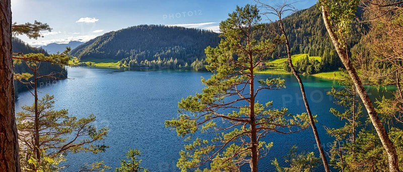 Clear blue lake surrounded by forests and mountains, Austria, Hintersteinersee, panorama