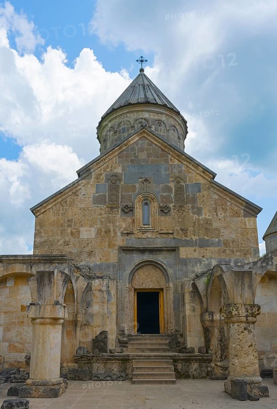 Front view of a stone church with distinctive entrance and tower in front of sky, Haghartsin monastery, Hagarzin, Tavush province, Armenia