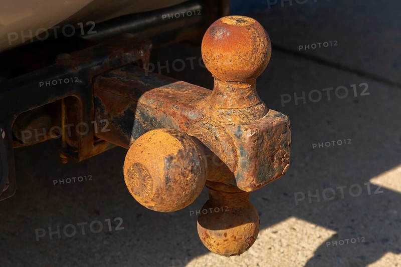 Close-up of rusted tri-ball trailer hitch attached to sport utility vehicle, Quebec, Canada