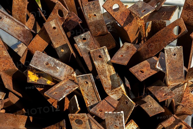 Close-up of pile of old rusted steel support brackets with bored holes, Quebec, Canada