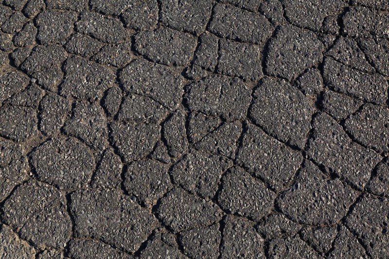 Top view and close-up of cracked asphalt road surface, Quebec, Canada