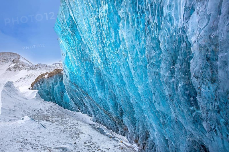 Glacier wall showing smooth melting blue ice made of compressed snow, Spitsbergen / Svalbard, Norway
