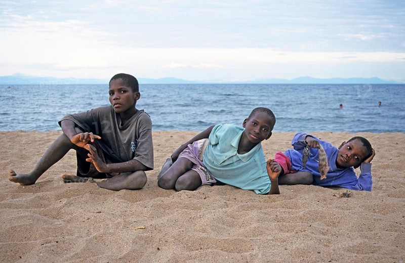 Three local boys posing for the camera on the beach, Chitimba, Lake Malawi, Africa, July 2000, vintage, retro, old, historic
