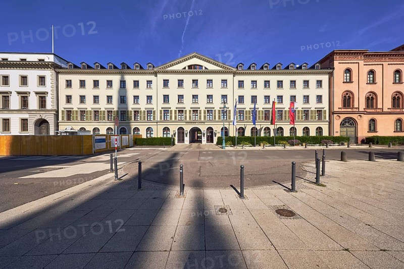 Hessian state parliament, former court marshal's office, classicism style, entrance area, façade with windows and shutters, dormers, entrance door, flagpoles, flags, Israeli flag, German flag, European flag, flag of Hesse, sidewalk, sidewalk tiles, barrier bollards, blue sky, cirrus clouds, castle square, Wiesbaden, state capital, district-free city, Hesse, Germany
