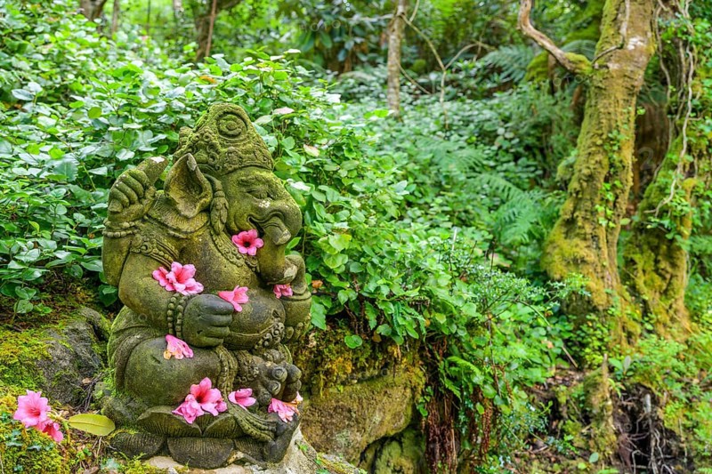 Rhododendron flowers on Ganesha statue in parkland near the castle, Glenveagh National Park, Cross Roads, County Donegal, Ireland