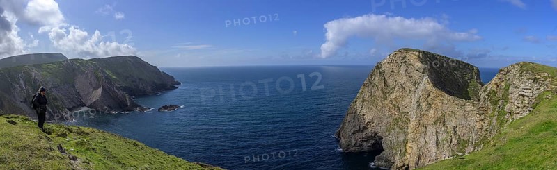 View of blue sea and cliffs with rock gate from Portacloy Loop Cliff Walk, Muingnabo, County Mayo, Ireland