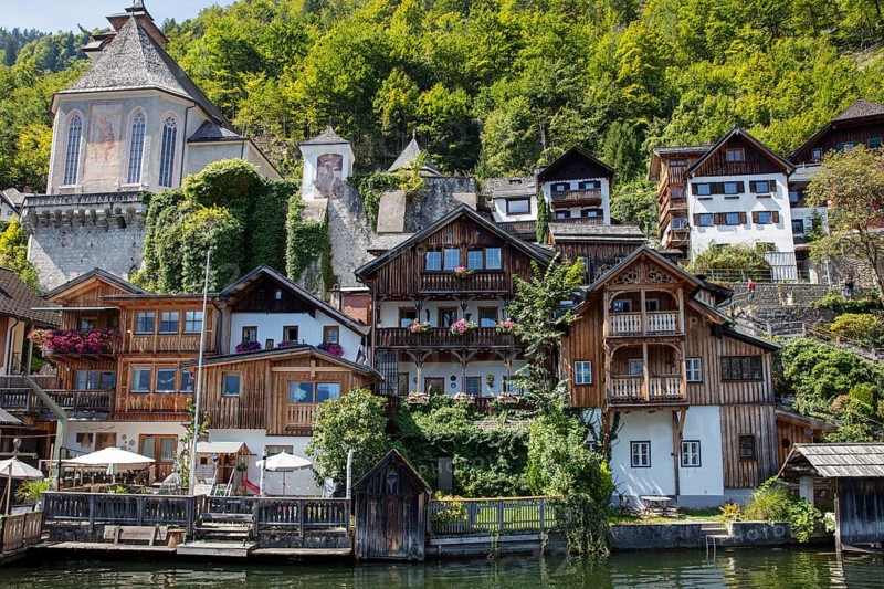 A, Hallstatt, central European village with old wooden houses on the water, surrounded by nature, Austria