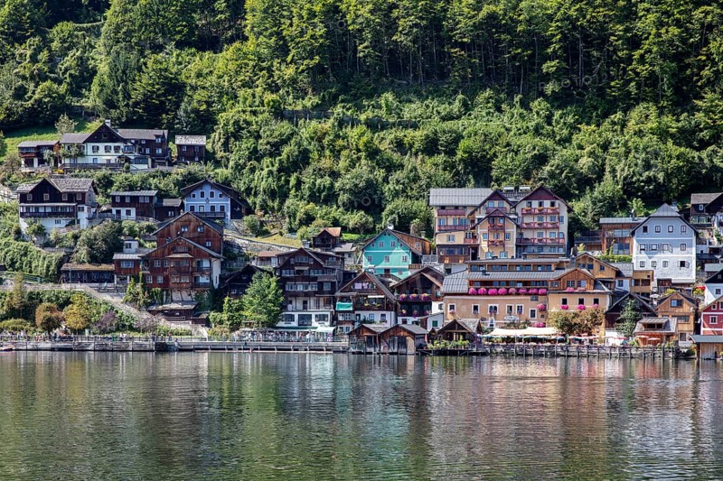 A, Hallstatt, Houses of various colors along a calm body of water, surrounded by trees, Austria