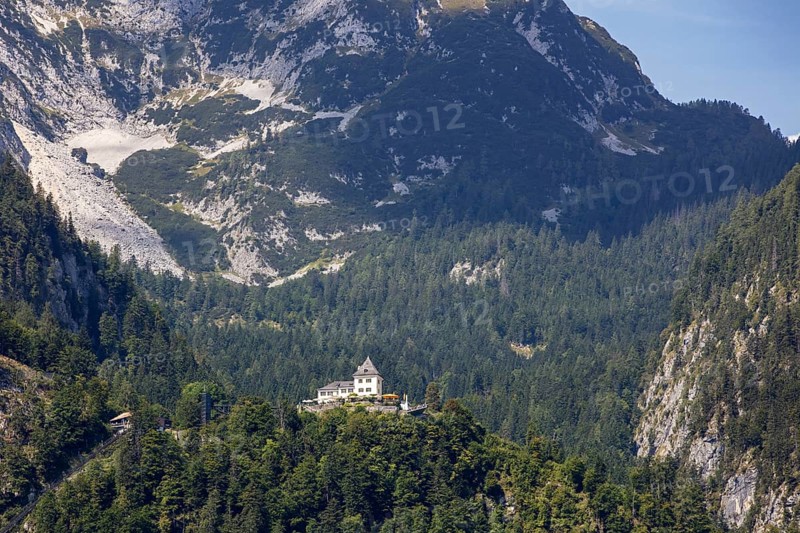 A, Hallstatt, A majestic castle perched high on a wooded mountain peak, Austria