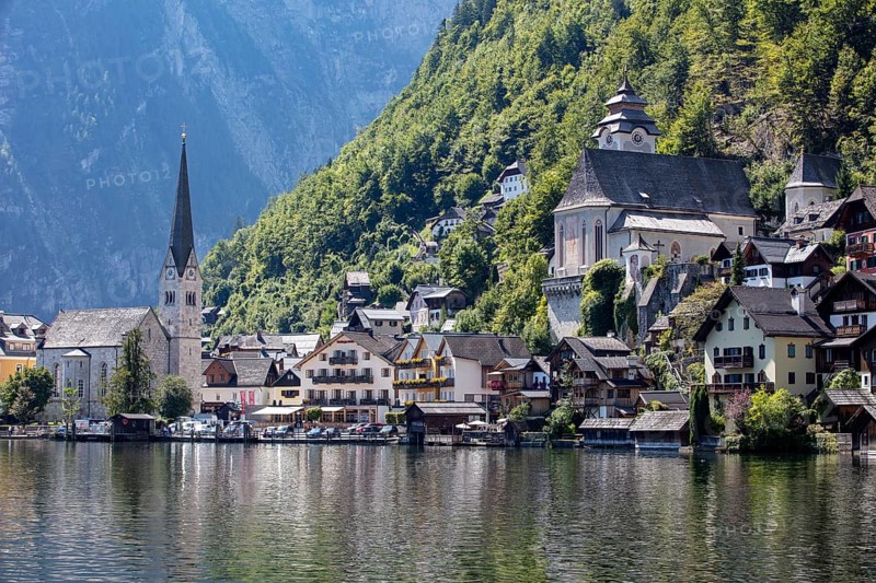 A, Hallstatt, An idyllic village with a lakeside church, surrounded by wooded mountains, Austria