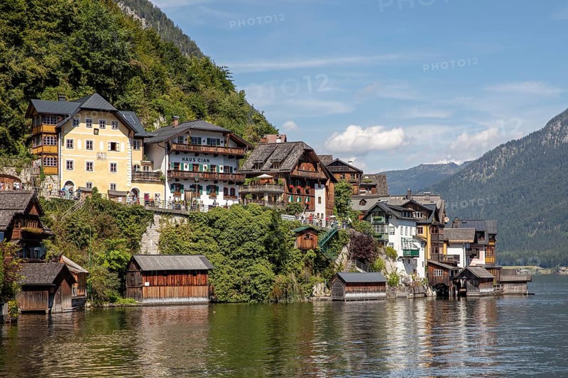 A, Hallstatt, picturesque buildings and traditional houses along the water, surrounded by mountains, Austria