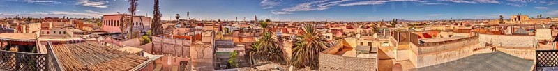 Panoramic view over rooftops of a historic city with blue skies