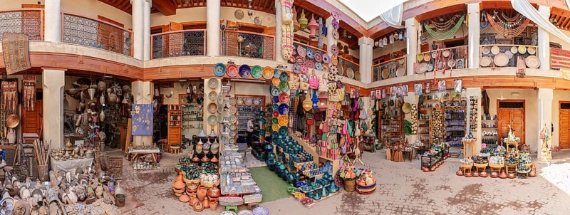 A colorful Moroccan market with pottery and crafts in a traditional setting