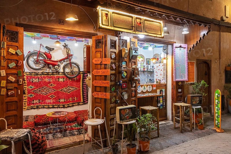 Colourful cafe with decoration and lights, a wheel hanging on the wall