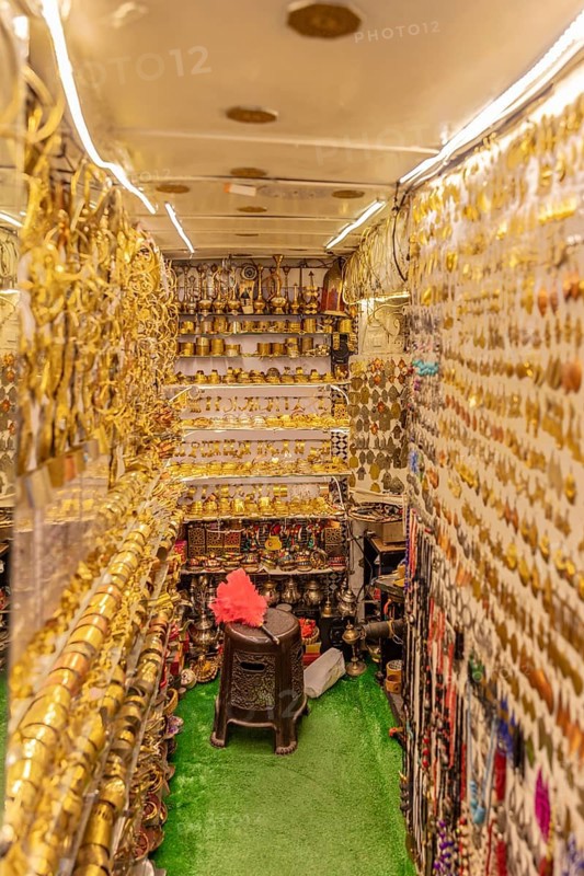 Tight shop full of shiny golden decorations and traditional goods