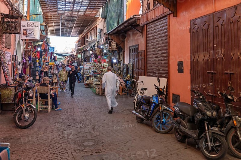 Alley with motorbikes and lively alleyway scenery in a market area