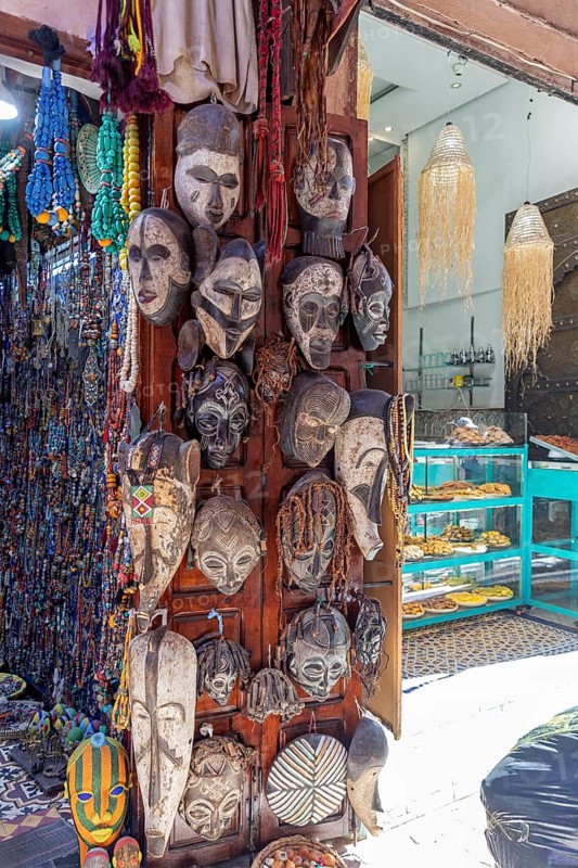 Traditional African decoration with wooden masks and pearls in a shop