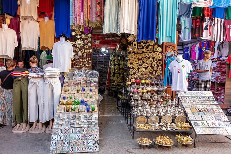 Lively marketplace with colorful clothing and ceramics, traditional charm