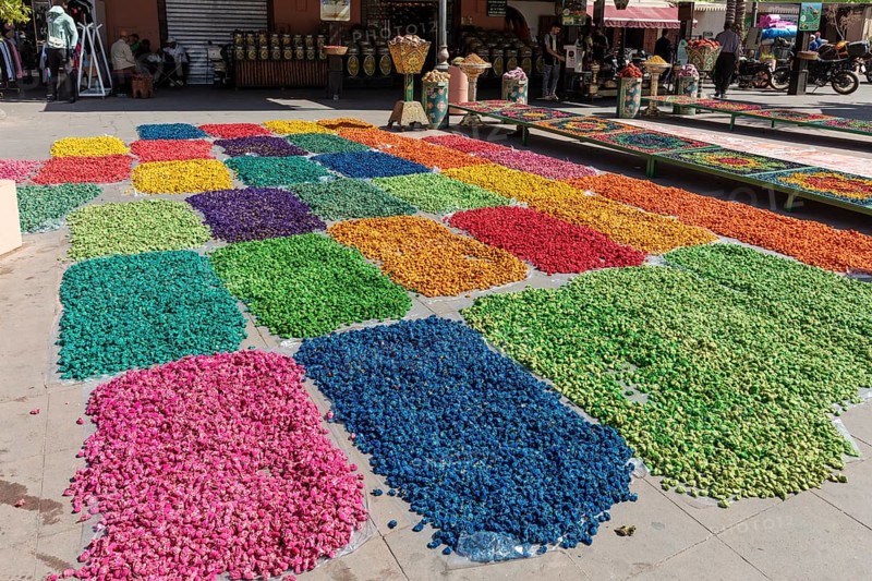 Colourful flower petals in creative patterns on an outdoor marketplace