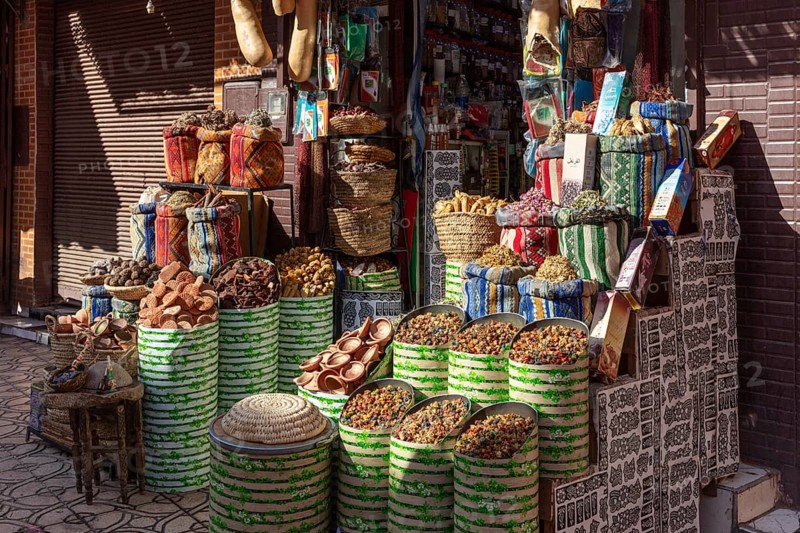 A colorful spice market in Marrakesh with bags and baskets full of fragrant spices and bright substances