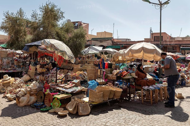 A lively marketplace with stalls full of baskets and crafts
