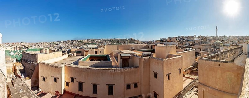 Panoramic view of the rooftops of a historic old town in strong sunlight