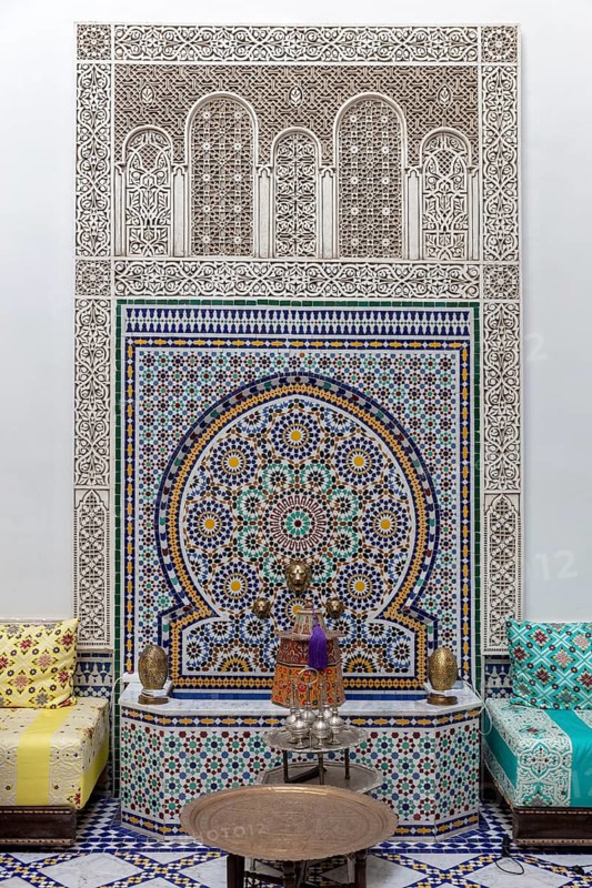 Richly decorated wall decoration with mosaics and traditional seating furniture