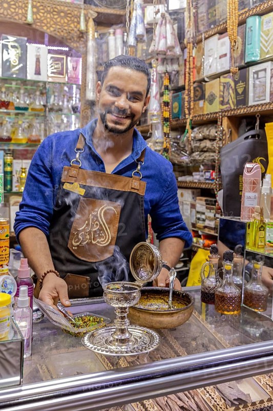 Friendly seller offers products in a busy bazaar