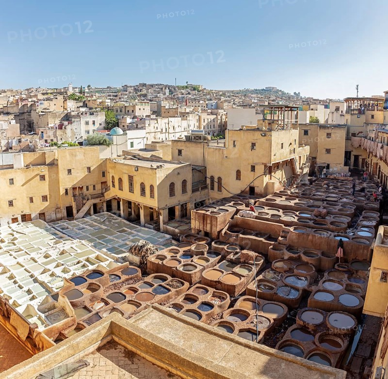 View of a traditional tannery in the old town of Fez under clear skies