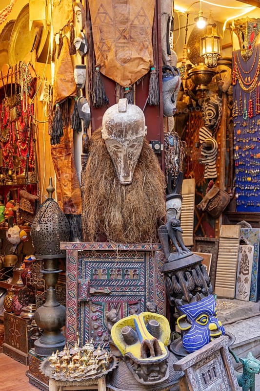 A shop full of colorful masks and tribal crafts with unusual decorations