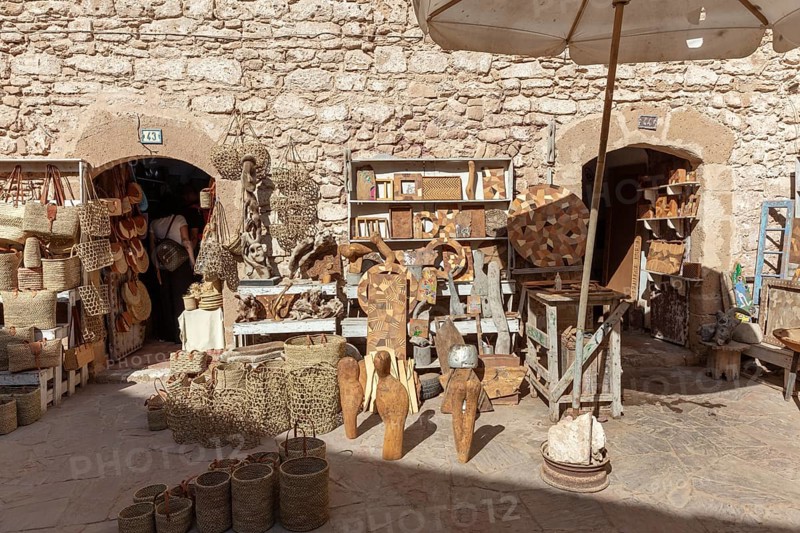 Handicraft market in an area surrounded by stone walls with traditional crafts and statues