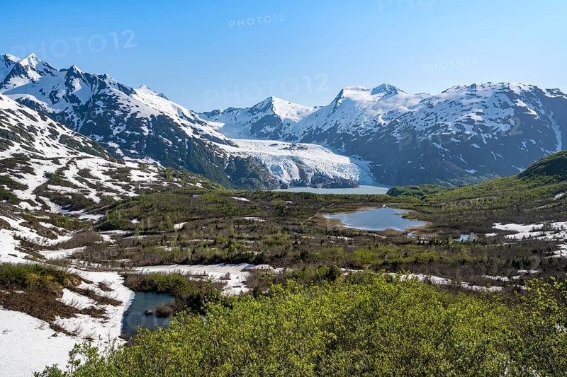 View from Portage Pass of Divide Lake, snowy mountain peaks and glaciers Portage Glacier, Portage Pass Trail, near Whittier, Alaska, USA