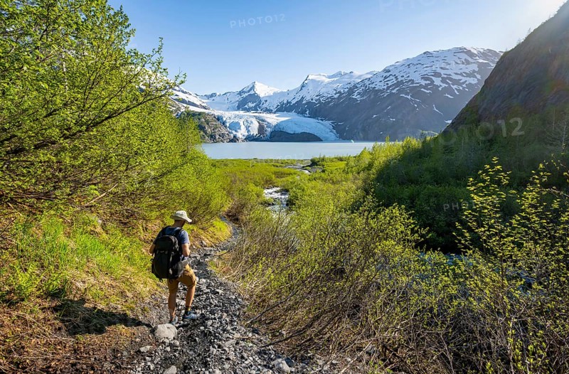 Hikers on the Portage Pass Trail, snowy mountains, Portage Glacier and Portage Lake, near Whittier, Alaska, USA