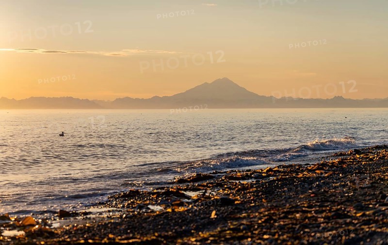 View of Cook Inlet on white mountain peaks of Mount Redoubt at sunset, midnight sun, Aleutian mountains, Anchor Point, Anchor River State Recreation Area, Alaska, USA