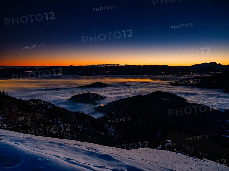 Alpine panorama at dawn in winter, fog in the valley, partly illuminated from below, Untersberg, Marktschellenberg, Berchtesgadener Land, Upper Bavaria, Bavaria, Germany