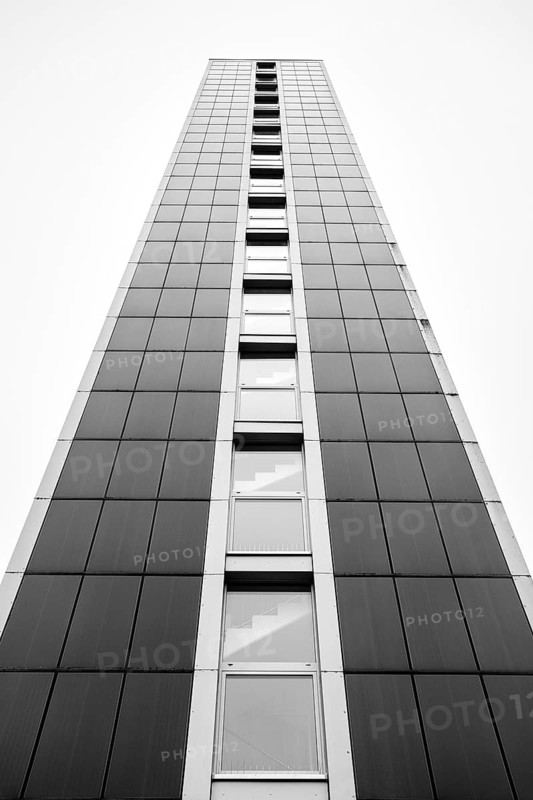 Modern architecture, geometric lines photographed in black and white, former water tower of the Radolfzell dairy plant, converted into the Hotel Aqua-Turm since 2017. The world's first zero-energy passive high-rise building, the entire façade consists of around 1000 photovoltaic modules and uses solar thermal wind power and hydrothermal energy to produce more energy than it consumes, Konstanz district, Baden-Württemberg, Germany