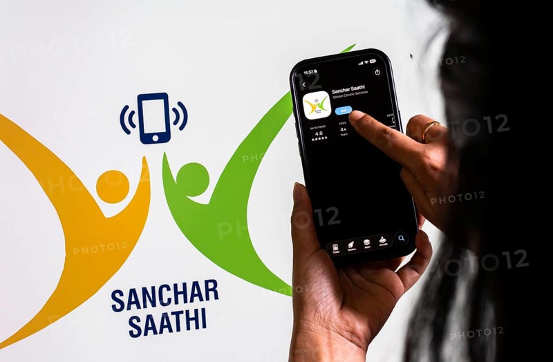 In this photo illustration, a person downloads the Sanchar Saathi mobile application on an iPhone, in New Delhi, India on 3 December 2025. Sanchar Saathi is officially developed and operated by the Department of Telecommunications (DoT), Government of India as part of its citizen-protection and telecom-security initiative
